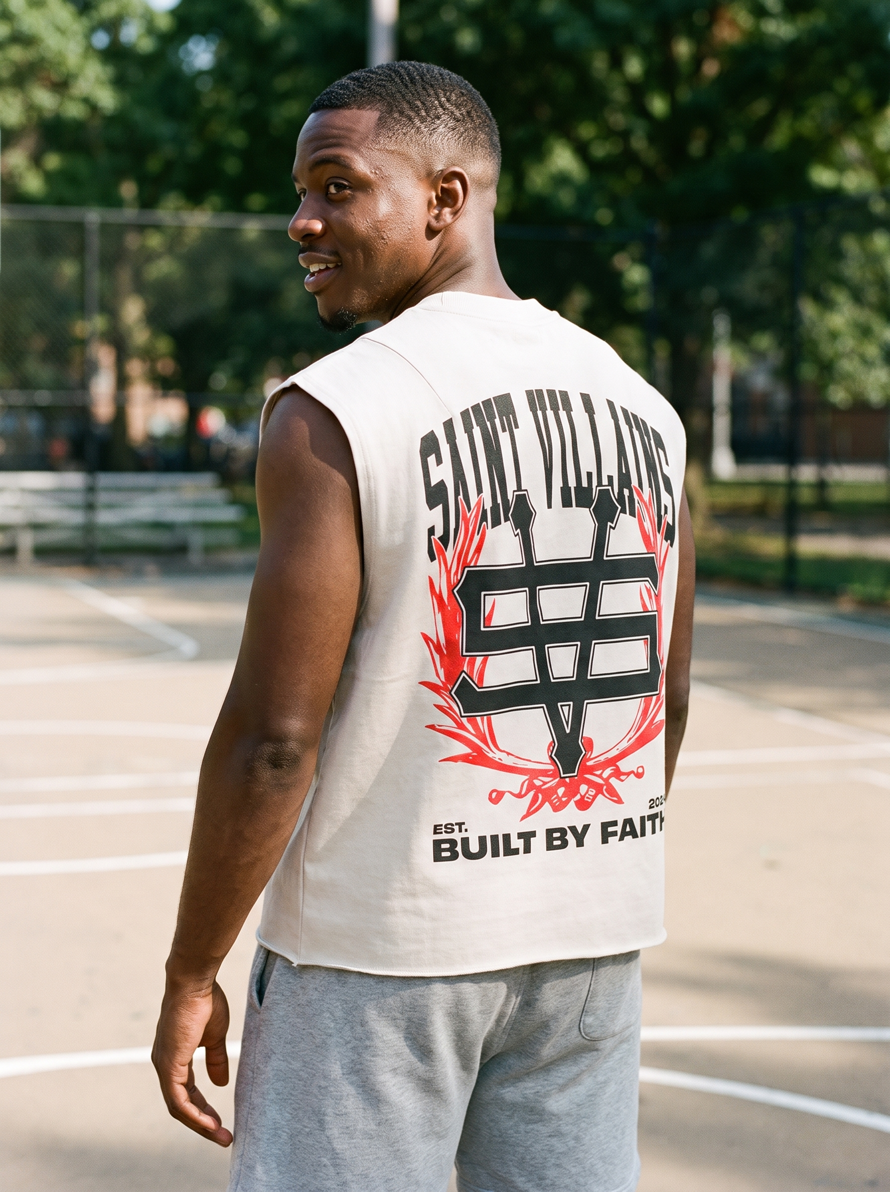 Saint Villains Built By Faith light beige cut off tank on basketball court